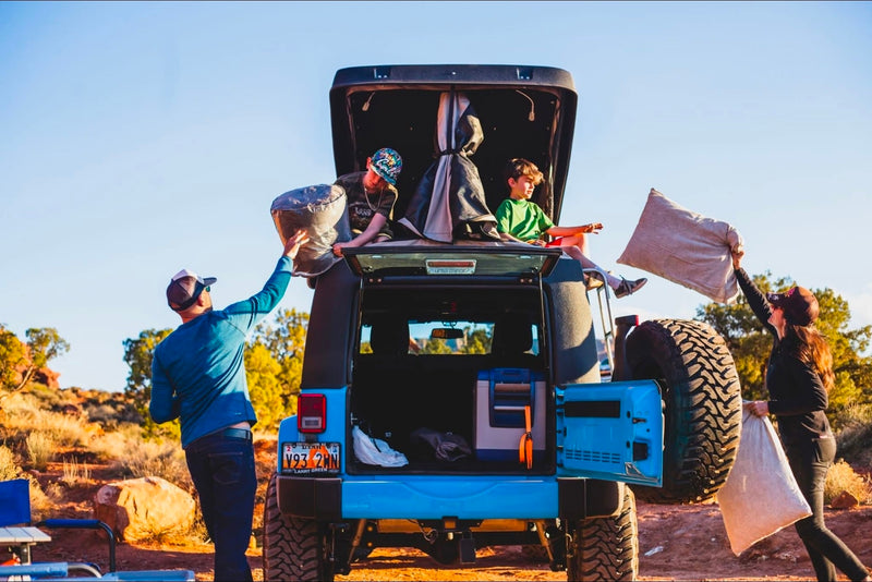  a blue Jeep with a rooftop tent — photo 12