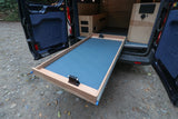 This RV rental's van conversion reveals a spacious pull-out cargo tray with a bike fork mount for gear.
