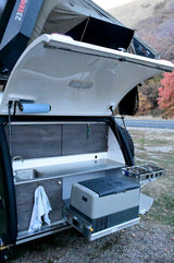 RV rental: Teardrop trailer's open rear galley with a sink, fridge, and stove for convenient outdoor cooking.