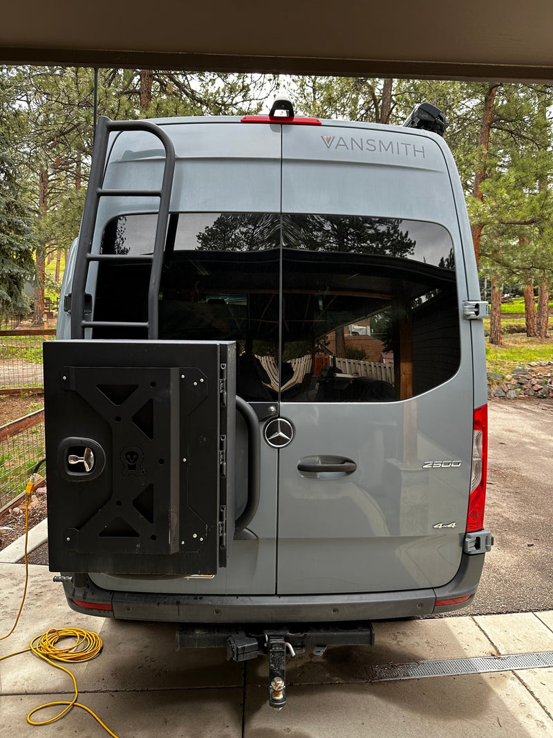 A gray Mercedes-Benz Sprinter RV rental's rear, featuring a ladder, cargo box, and tow hitch for adventures. — photo 10