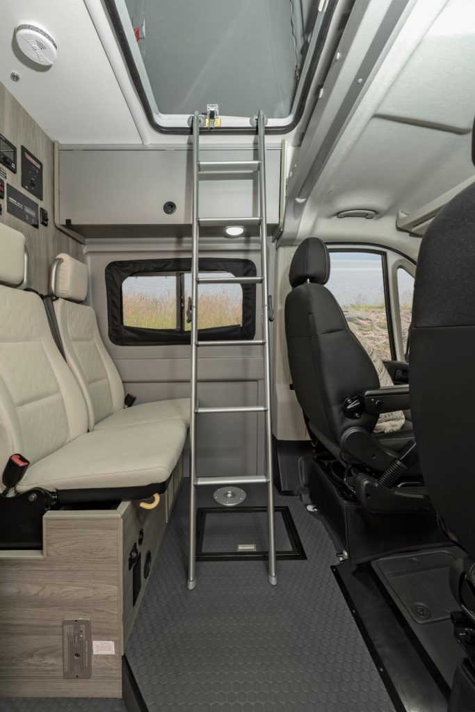  ready for your outdoor adventure.|Modern rv rental interior: A ladder accesses a pop-top — photo 4