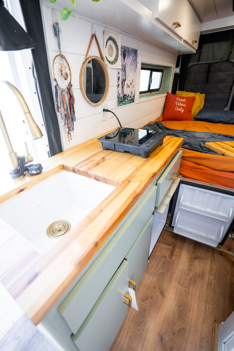  looking out to a sunny street.|Interior of a clean RV rental van — photo 10