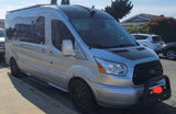 This silver Ford Transit camper van RV rental features a high roof, custom wheels, and a front bull bar.