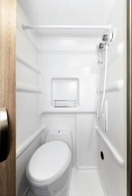  and sunflowers by the window.|Camper van interior: spacious RV rental bed with storage below for gear & firewood. Ideal for road trip adventures.|Inside a comfortable RV rental: a bed with an open book — photo 10