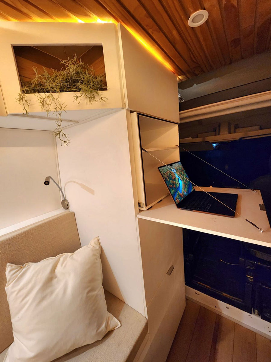  parked in a lot. Ideal rv rental for adventure.|This sleek dark gray camper van rv rental features an open kitchen setup