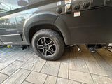 Side view of an RV rental's rear wheel with Nexen tire and Fast wheel, plus essential utility hookups for cable/satellite & power.