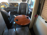 Comfortable rv rental interior: Mercedes cab, swiveling front seats, wooden dinette table with cup holders, Nova Kool fridge.