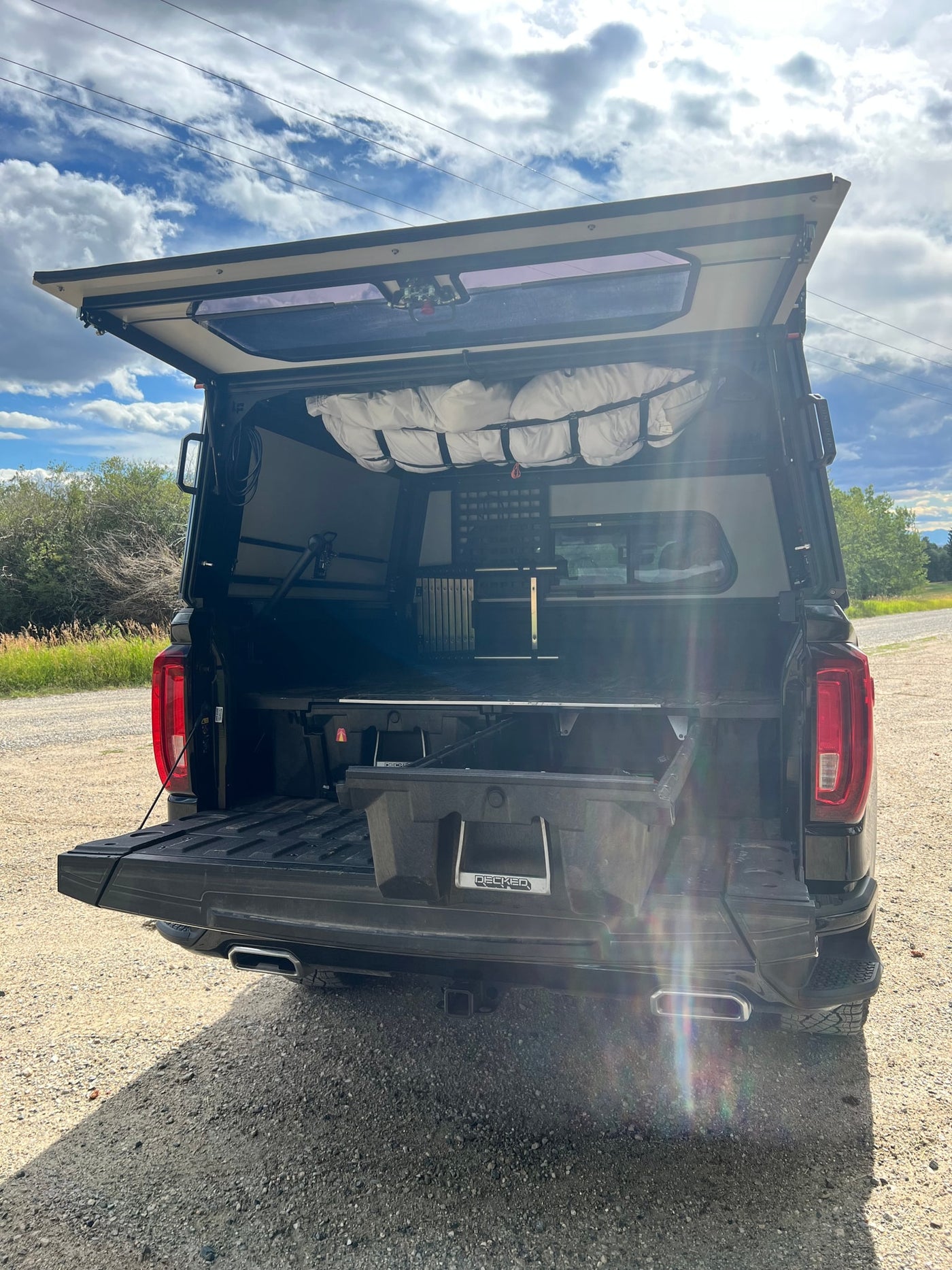 Overland truck with open camper shell reveals organized storage, ready for adventure. A versatile option beyond a typical RV rental for off-grid trips. — photo 11