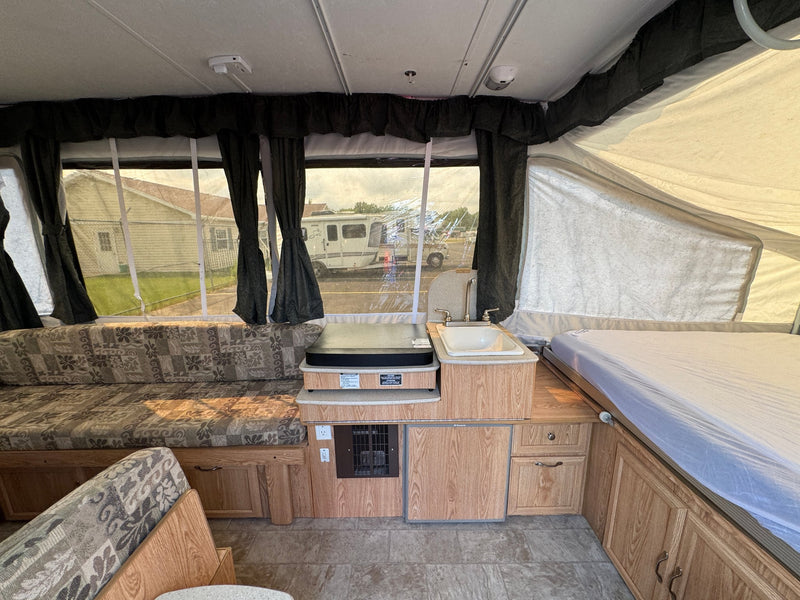  other RVs are parked.|RV rental pop-up camper floor plan featuring front/rear bunks — photo 6