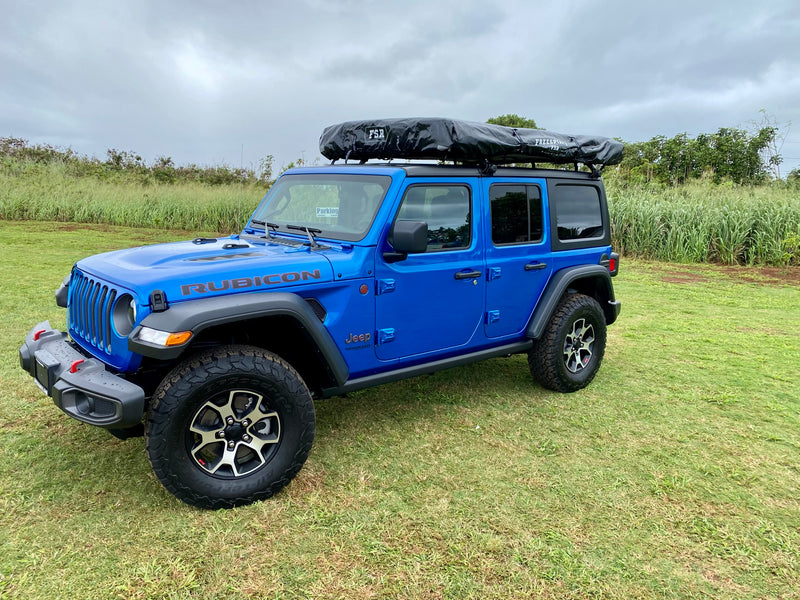 This blue Jeep Wrangler Rubicon with a rooftop tent is an ideal RV rental for off-road adventures. — photo 1