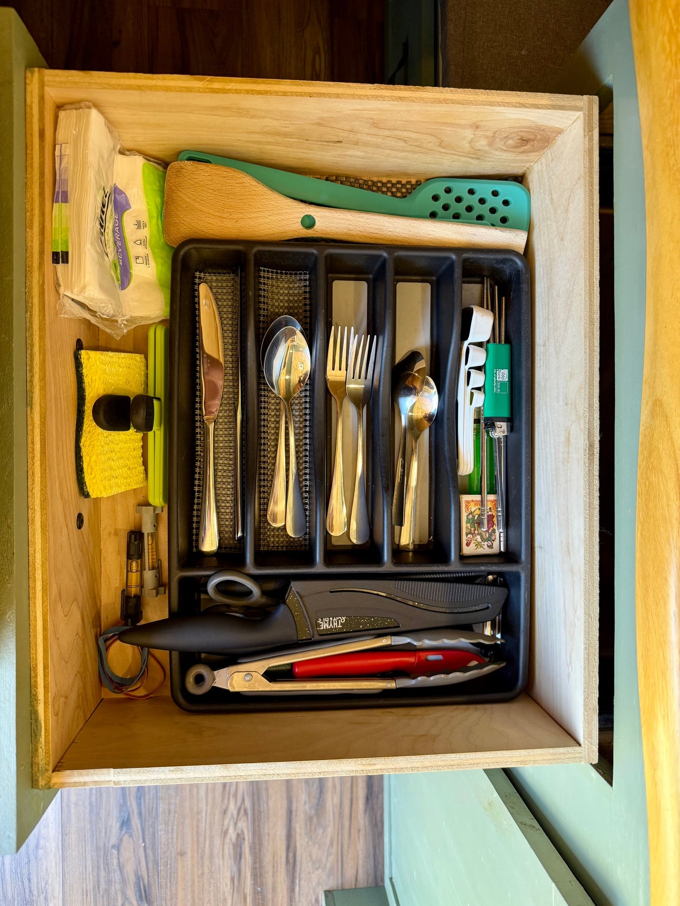 Inside an RV rental: a neatly organized kitchen drawer with silverware, cooking utensils, and essential supplies. — photo 14
