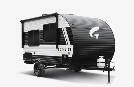 Compact black & white travel trailer, a perfect RV rental for your off-grid camping adventure.