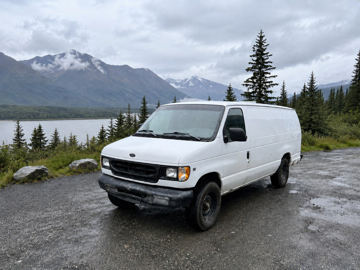  parked on gravel overlooking a scenic lake and misty mountains. Perfect for van life adventures!|Experience comfort in this RV rental van conversion — photo 5