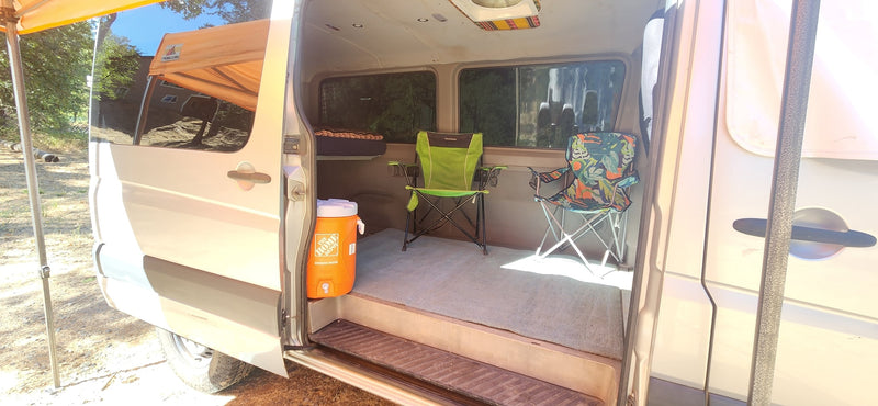  and a ceiling fan for comfort.|Cozy RV rental interior with a raised bed — photo 8