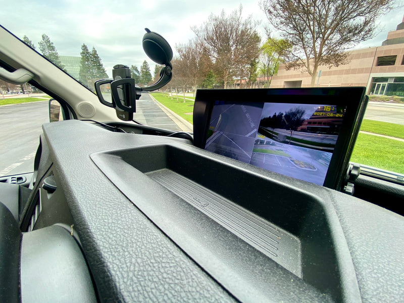  showing the dashboard & view of water park slides.|Spacious RV rental interior featuring a cozy bed — photo 10