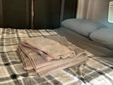  and two glasses set for dining.|RV rental interior: Compact camper van kitchen with sink