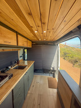 RV rental camper van: wood ceiling, kitchenette, and a stunning view of the Golden Gate Bridge. Ready for adventure.
