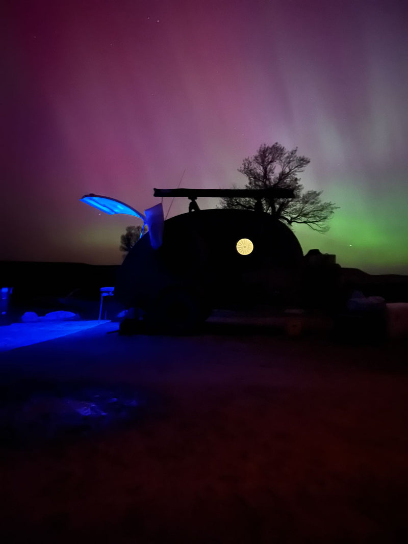 Unique RV rental under vibrant Northern Lights. Experience celestial views & unforgettable night adventures!|Explore with this rugged green teardrop camper — photo 1