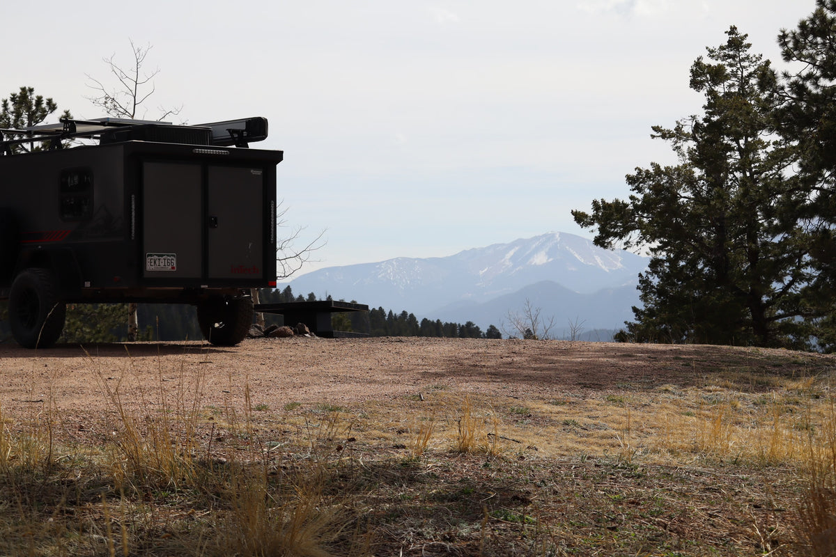 Overland RV rental trailer at a picturesque Colorado mountain campsite with snow-capped peaks. Perfect for outdoor adventure. — photo 19