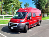 Bright red Winnebago Solis camper van, ideal for your next RV rental adventure, parked on a sunny day.