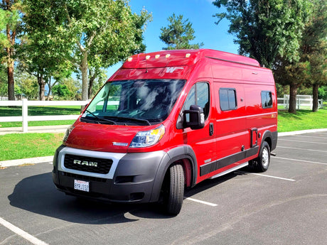Bright red Winnebago Solis camper van, ideal for your next RV rental adventure, parked on a sunny day.
