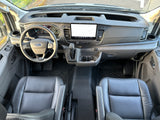 Modern Ford Transit van interior, featuring dashboard, touchscreen, and front seats, ready for rv rental.