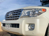 Front view of a white Toyota Land Cruiser SUV, a robust choice for your next rv rental adventure, with a visible roof rack.