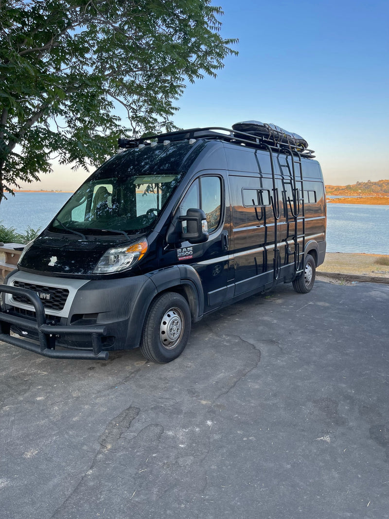  and sunny outdoor view.|Black Dodge Ram camper van for RV rental — photo 8