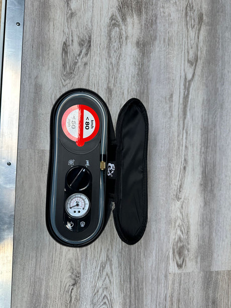 RV rental emergency tire repair kit. Black case shows pressure gauge, hose, and temporary repair speed limits for safety.