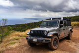 Experience Hawaii's coast with this muddy Jeep Gladiator, featuring an iKamper rooftop tent. Ideal for an rv rental adventure.