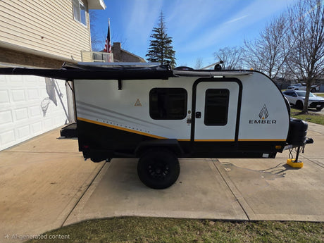 Compact Ember E-Series Spark LE camper parked on a driveway. Ideal for an rv rental adventure!