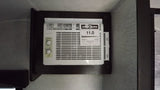 RV rental AC unit: A Frigidaire air conditioner with an 11.0 EnerGuide rating, mounted in a dark wooden frame in an RV.