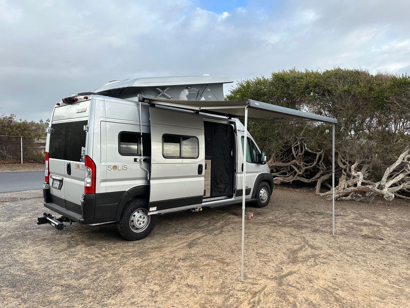  under a stunning pink and blue sunset sky.|Silver camper van with pop-top & awning extended — photo 2