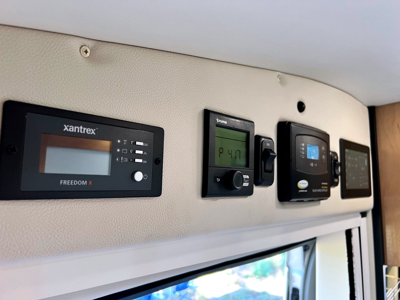 RV rental's control center: Xantrex inverter, Truma heater, & battery monitor. Vital systems for an RV adventure.