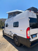 A white Solis camper van with a raised pop-top roof, from Blacksford rv rental, ready for an adventure.