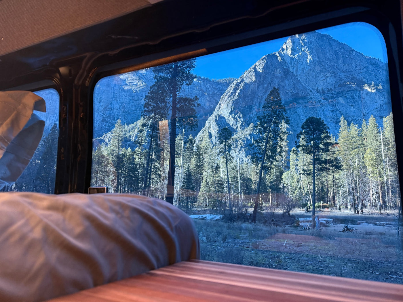 Gaze at majestic mountains and a serene forest from the window of your comfortable *rv rental*, offering a cozy nature escape. — photo 6