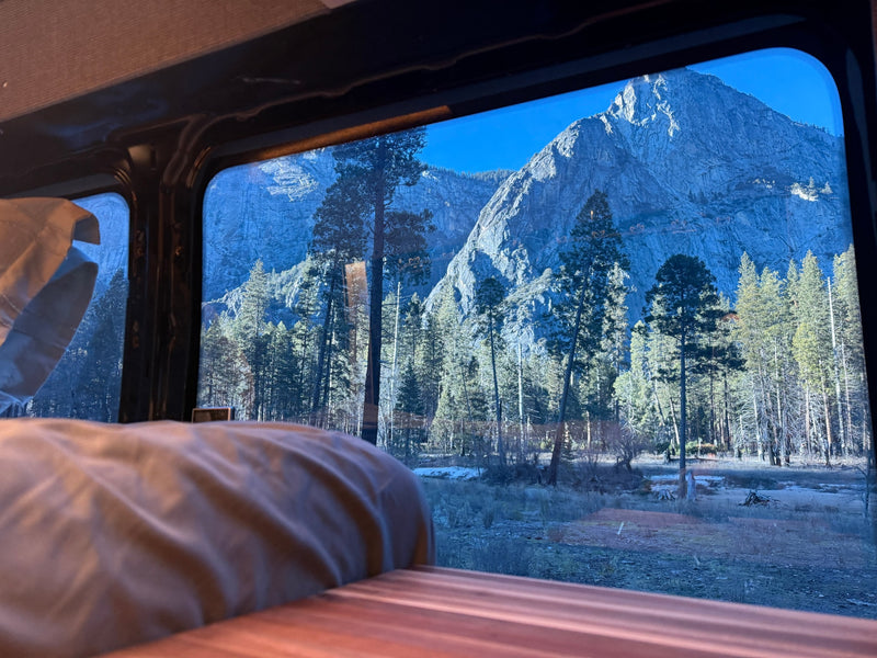 Gaze at majestic mountains and a serene forest from the window of your comfortable *rv rental*, offering a cozy nature escape. — photo 6