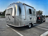 This iconic silver Airstream Bambi travel trailer and truck, parked and ready for your next RV rental camping trip.