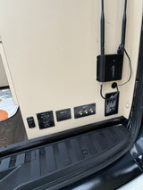 Inside an RV rental: entertainment/connectivity hub with Cradlepoint router, HDMI inputs (Apple TV, Blu-ray, Direct TV).
