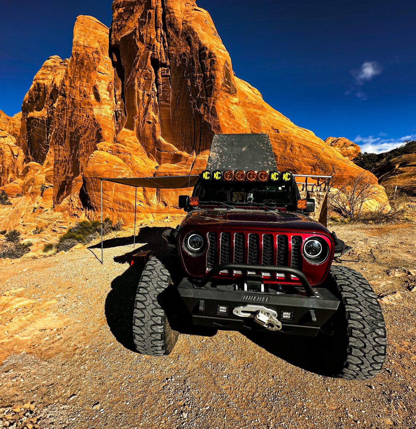 This rugged Jeep off-road vehicle with an awning is perfect for desert adventures. Explore red rock formations with an rv rental!