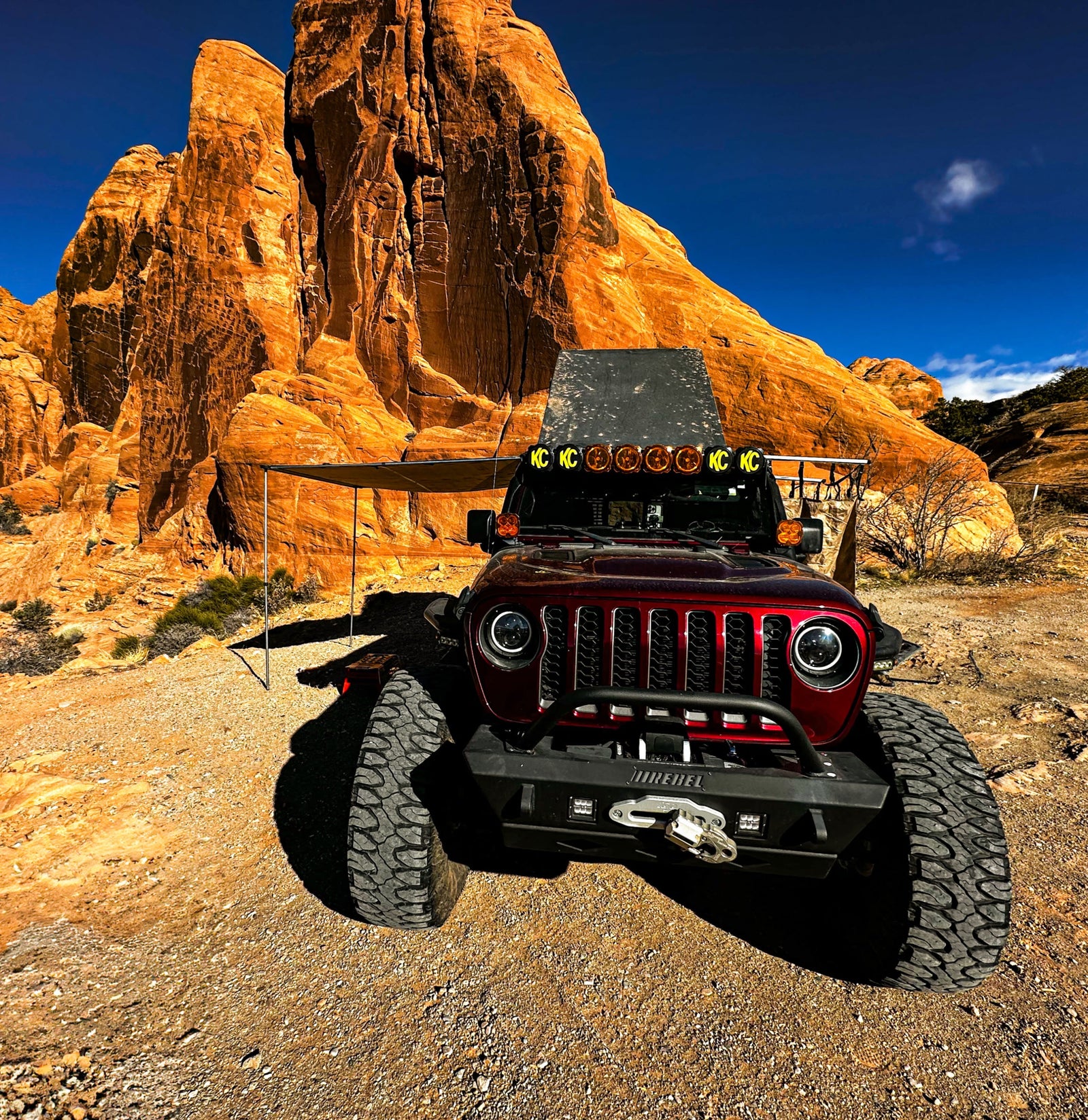 This rugged Jeep off-road vehicle with an awning is perfect for desert adventures. Explore red rock formations with an rv rental!