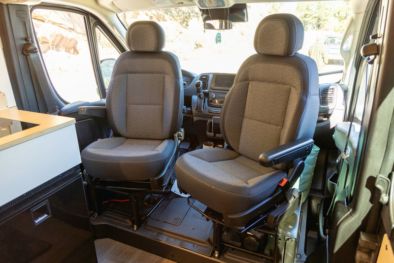 Interior of an RV rental camper van, showing swiveling front seats and cockpit area. — photo 18