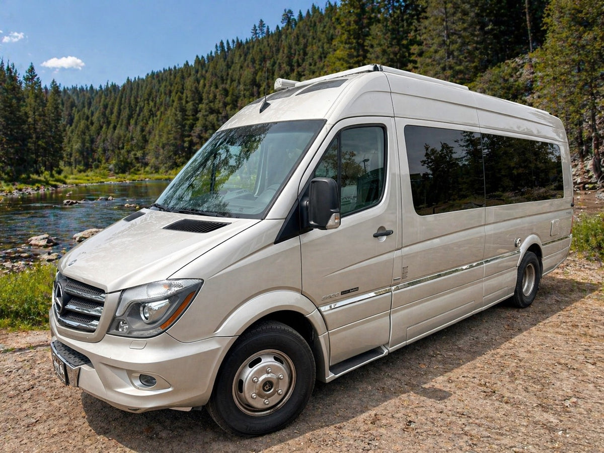 Mercedes-Benz Sprinter rv rental parked by a river in a forest, ready for adventure in a natural setting. — photo 2