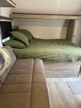  and a bed with green bedding. Black blinds are visible.|RV rental: This clean