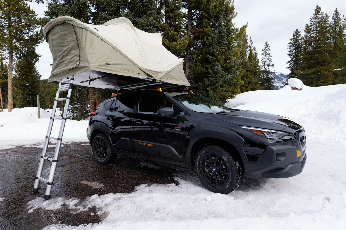 Black Subaru Crosstrek with rooftop tent parked in snow. This setup offers versatile outdoor camping, a great alternative to an rv rental. — photo 5