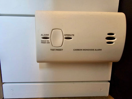 Ensure safety in your rv rental with this carbon monoxide alarm, showing its "ALARM," "OPERATE" lights, and "TEST/RESET" button.