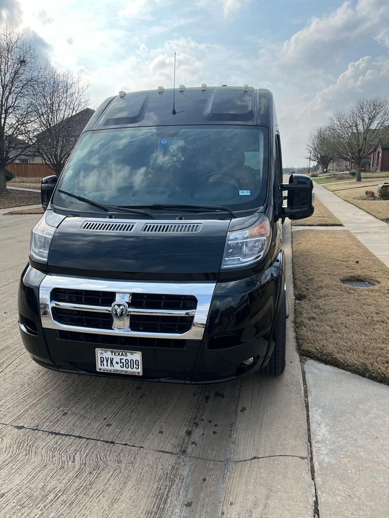 Black RV rental van, featuring roof lights & Texas plates, parked on a residential driveway. — photo 10