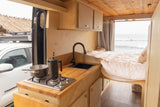 This rv rental camper van offers a full kitchenette, comfy bed, and stunning ocean views. Perfect for van life!