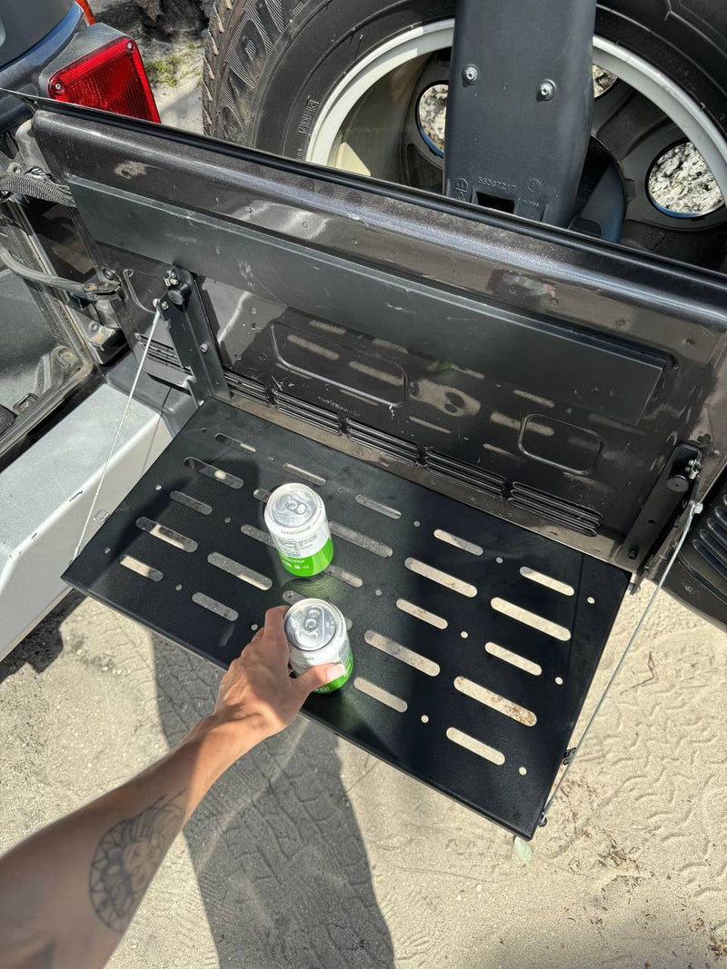 This RV rental's fold-down tailgate table holds two cans, providing convenient outdoor space. Ideal for your adventures. — photo 5