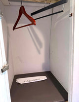 Compact RV rental closet: hangers, including a Vince Camuto one, and a laundry bag for your travel essentials.